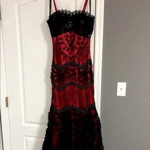 Red and black Eureka (S) mermaid prom dress. Beautiful beading and design work.